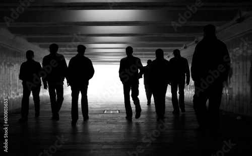People silhouettes in a subway tunnel