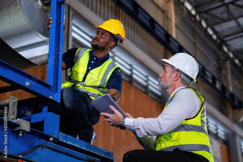 Plant manager advise engineer in factory production line discuss and trouble shooting broken machine