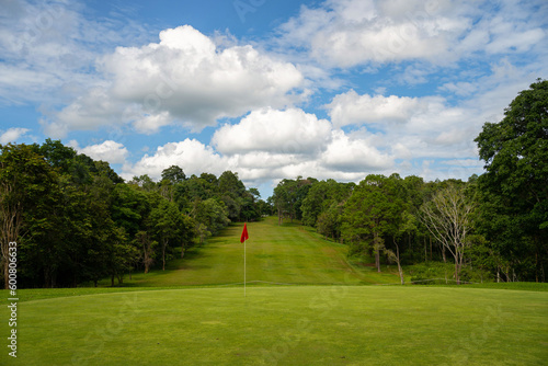 Background of evening golf course has sunlight shining down at golf course in Thailand.