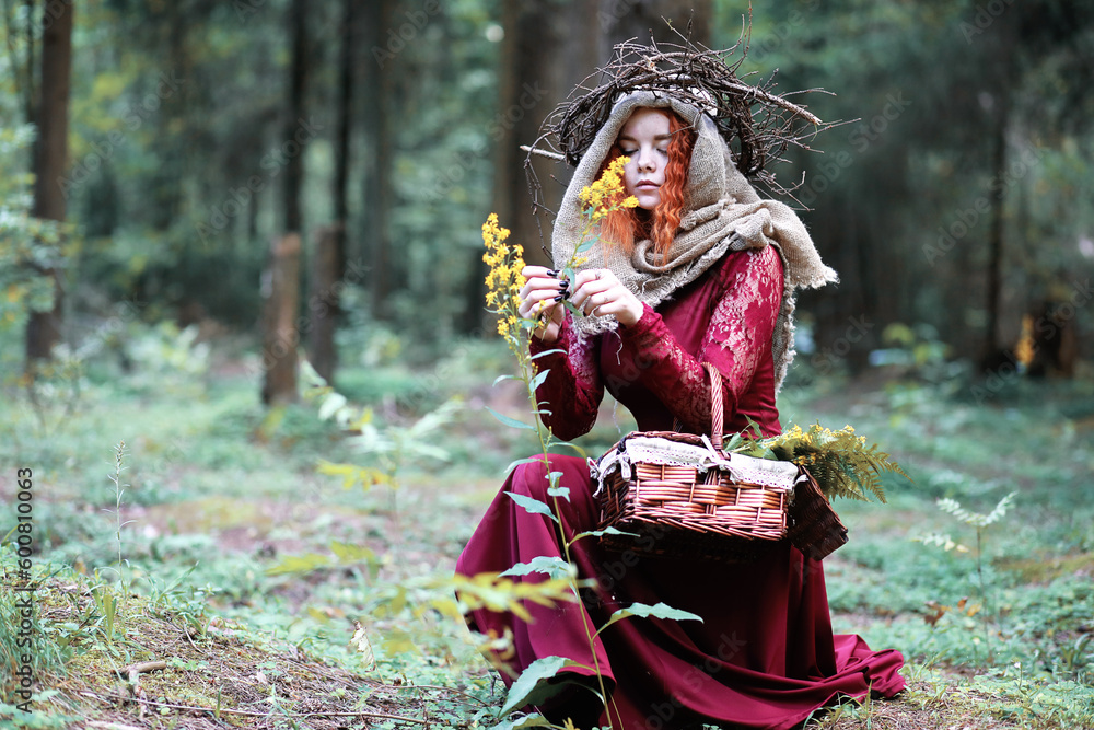 The red-haired witch holds a ritual with a crystal ball The red-haired witch holds a ritual with a crystal ball