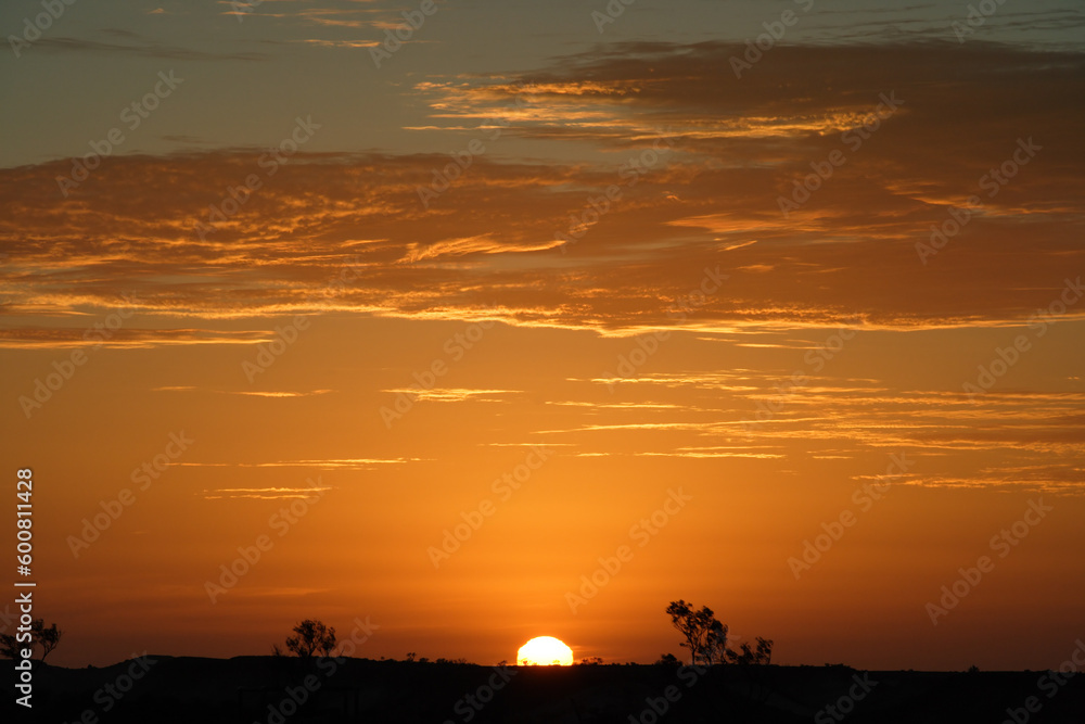 An image of the Australian Outback landscape during a sunset.