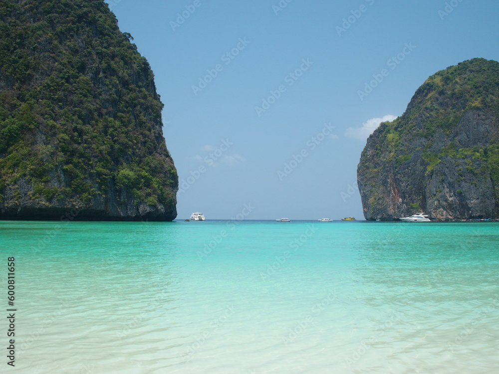 Beautiful sea, white sandy beach, tourist boats moored near Koh Phi Phi. Popular tourist destination with peaceful atmosphere. Maya Bay is located in Noppharat Thara Beach in Krabi Province, Thailand.