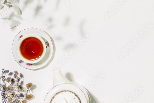 Te time. Healing herbal tea with wild plants and flowers. Sustainable morning composition with cup of tea  teapot and dry flowers on white background. Flat lay  copy space