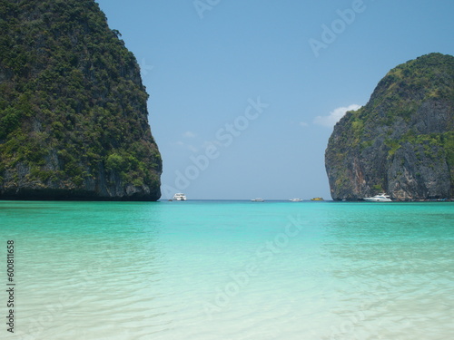 Beautiful sea, white sandy beach, tourist boats moored near Koh Phi Phi. Popular tourist destination with peaceful atmosphere. Maya Bay is located in Noppharat Thara Beach in Krabi Province, Thailand.