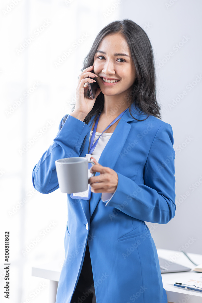 Cheerful employees business Asian woman freelancer making telephone call share good news about project working in office workplace, business finance concept. Cheerful employees business Asian woman freelancer making telephone call share good news about project working in office workplace, business finance concept.