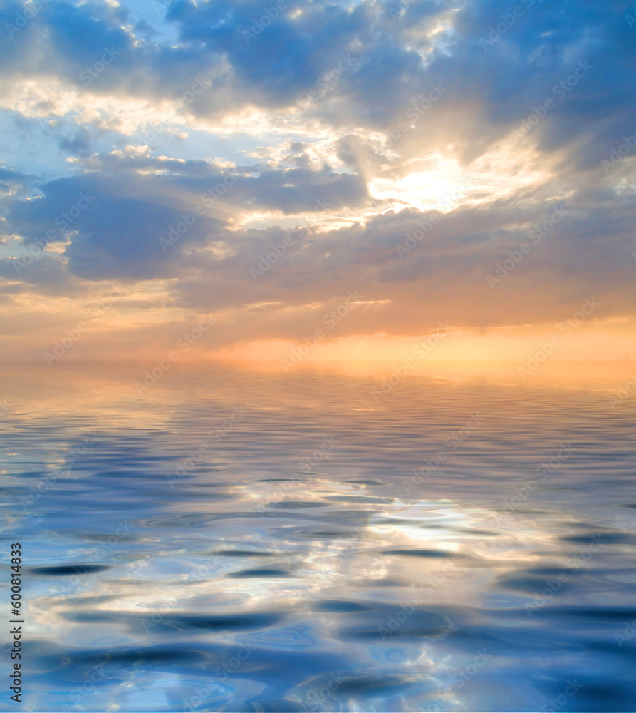 Sky with a visible sun rays and rippled water