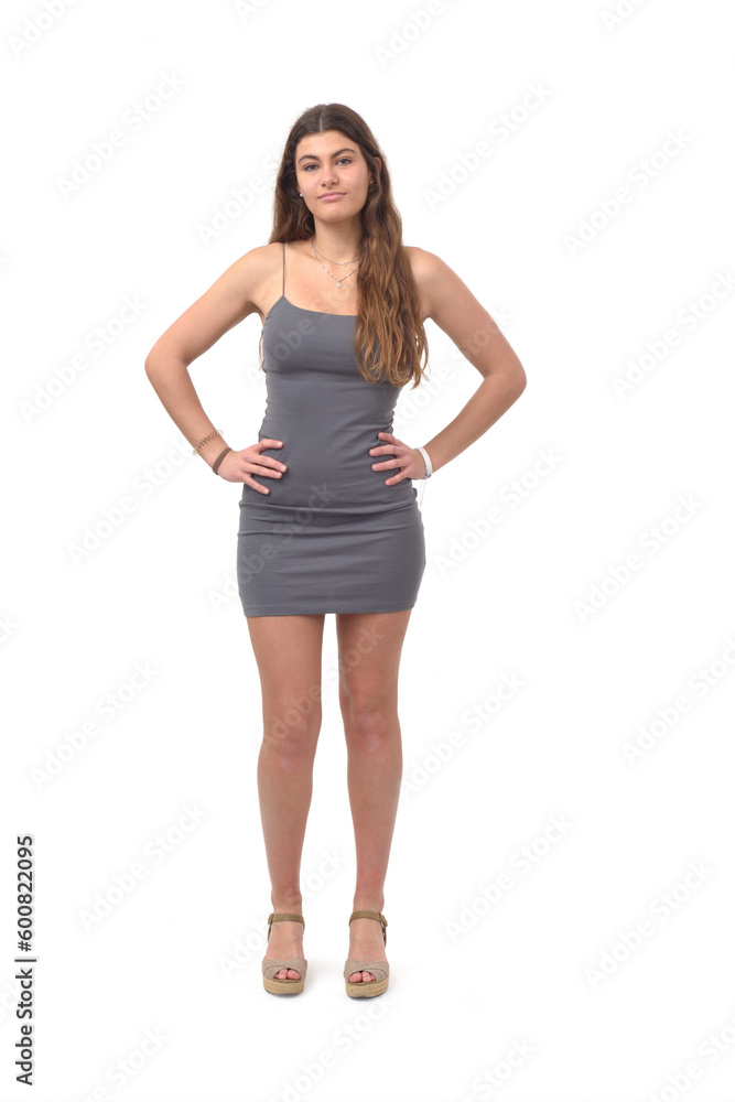 front view of young girl standing with arms akimbo and looking at camera on white background front view of young girl standing with arms akimbo and looking at camera on white background