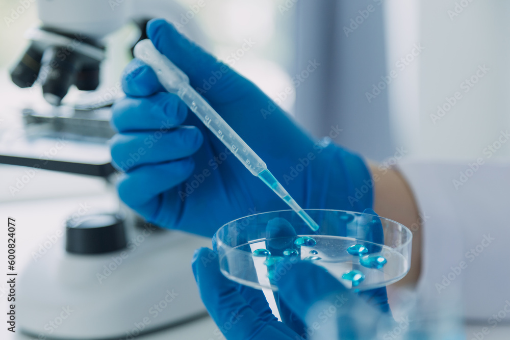 Fototapeta premium Medical Development Laboratory: Caucasian Female Scientist Looking Under Microscope, Analyzes Petri Dish Sample. Specialists Working on Medicine, Biotechnology Research in Advanced Pharma Lab