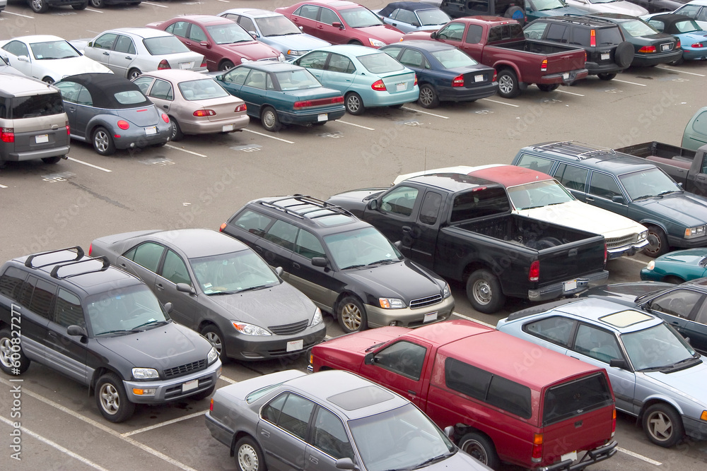 A parking lot crammed with cars. All trademarks have been removed. A parking lot crammed with cars. All trademarks have been removed.