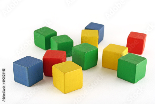 colorful wooden childen's building blocks scattered loose