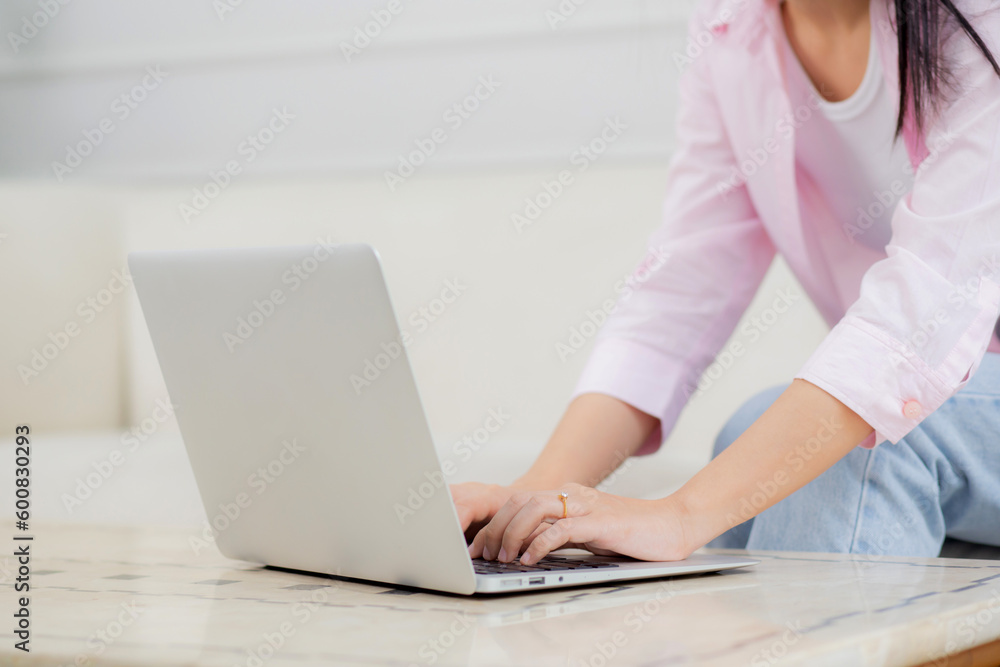 Young asian business woman work from home with laptop computer online to internet on sofa in living room, freelance is female using notebook sitting on couch with comfort and relax, lifestyle concept. Young asian business woman work from home with laptop computer online to internet on sofa in living room, freelance is female using notebook sitting on couch with comfort and relax, lifestyle concept.