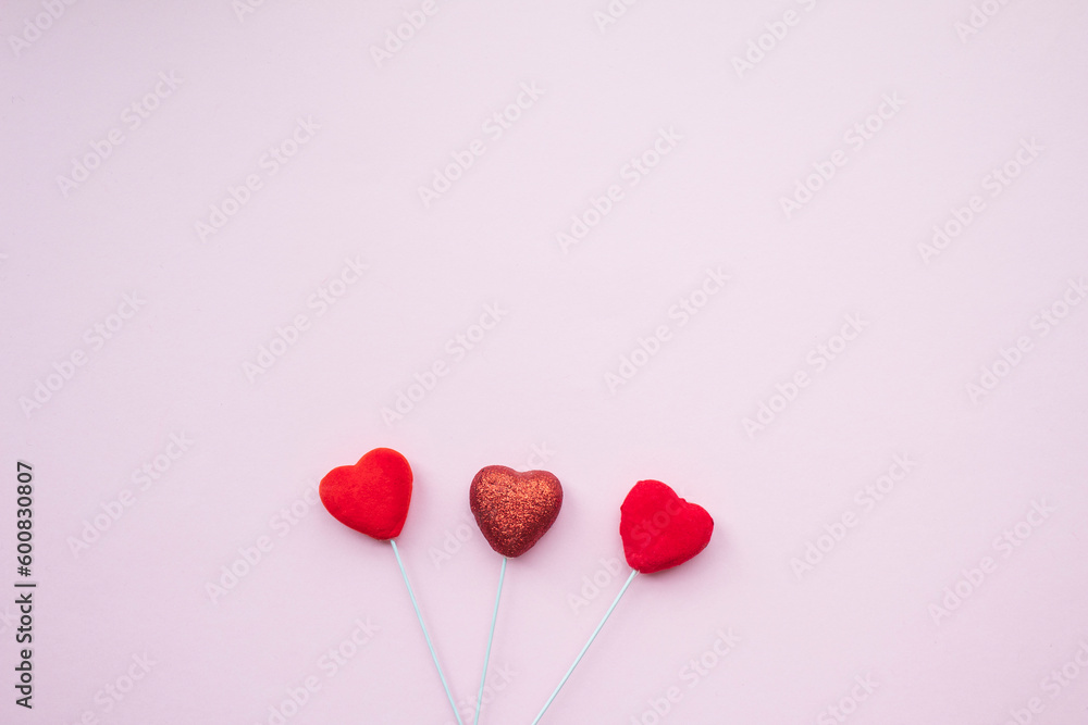 Fototapeta premium Heart sticks on pink background.