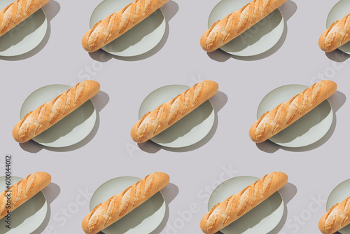 Creative food pattern with fresh french baguettes on plates. Minimal concept.