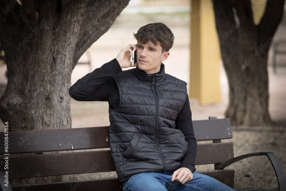 Young man speaking by phone Young man speaking by phone