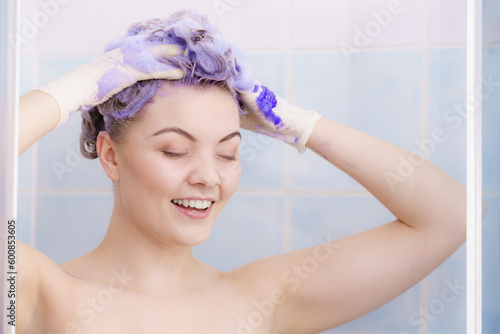 Woman applying toner shampoo on her hair