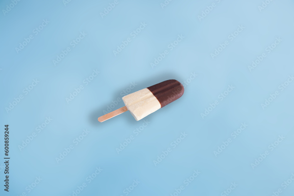 Ice cream made with chocolate and milk. Black and white ice cream on blue pastel background. Minimal summer food concept. Ice cream made with chocolate and milk. Black and white ice cream on blue pastel background. Minimal summer food concept.