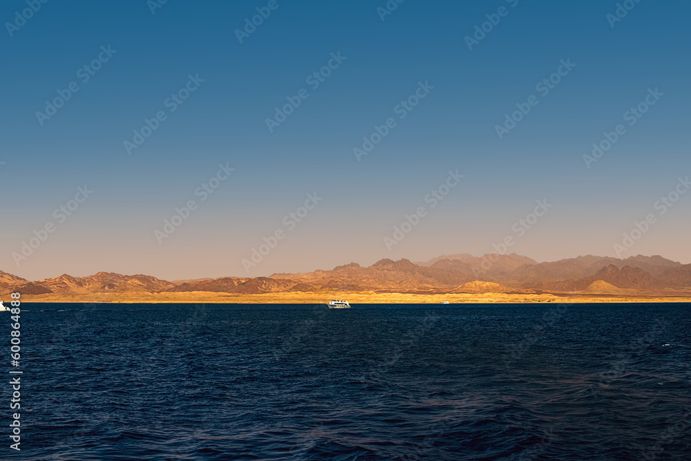 Beautiful view of the golden mountain coast from the azure sea. Red Sea, Egypt