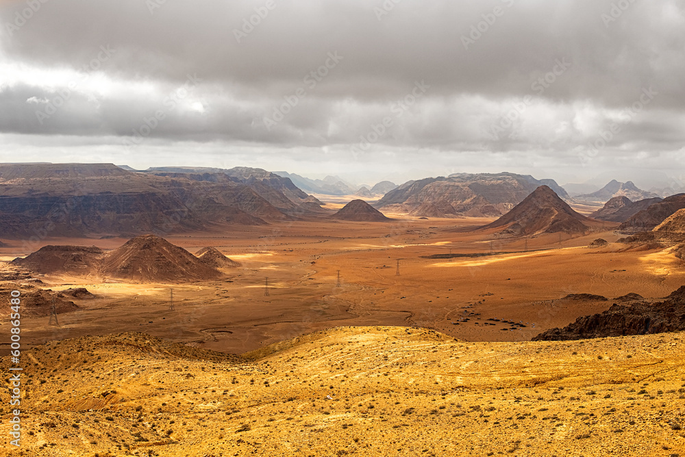 Fototapeta premium Top view of a canyon meandering through high sandstone mountains in the desert, Jordan