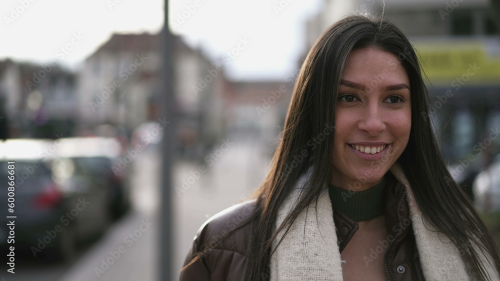 One young Middle Eastern adult girl walks in urban city street with confident proud expression. Closeup face of an Arab woman One young Middle Eastern adult girl walks in urban city street with confident proud expression. Closeup face of an Arab woman