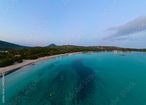 Mesmerizing Aerial Drone Footage of Santa Giulia Beach, Porto-Vecchio, Corsica - An Exquisite Sunset Panorama Amidst Clear Blue Waters and Verdant Scenery