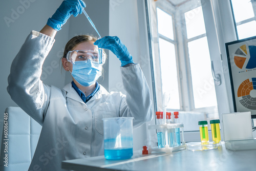 Scientist, chemist conducting an experiment on the synthesis of a new pharmaceutical drug in the laboratory. Research in a medical laboratory to identify new ways to diagnose and treat cancer.