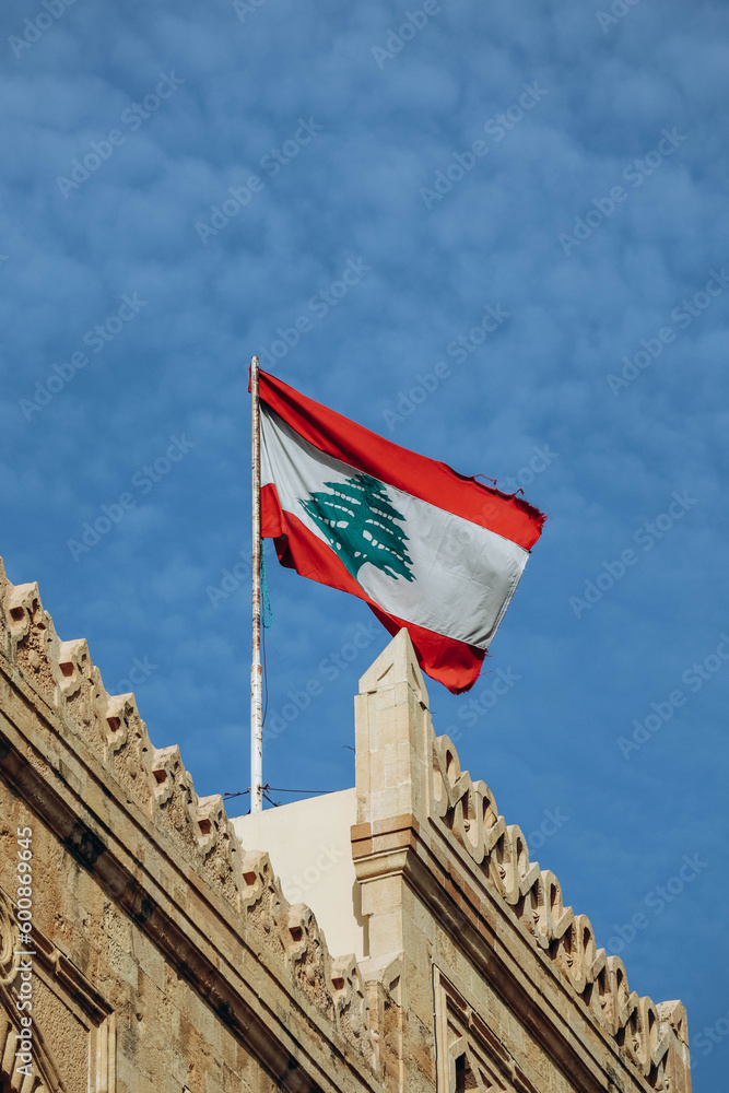 Naklejka premium The Lebanese flag in the center of Beirut fluttering in the wind
