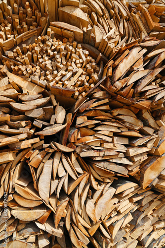 Pile of boards and bark from spruce tree in wood industry for further processing in the sawmill. Close-up, texture