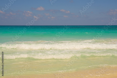 Waves with foam on the Caribbean coast in Mexico.