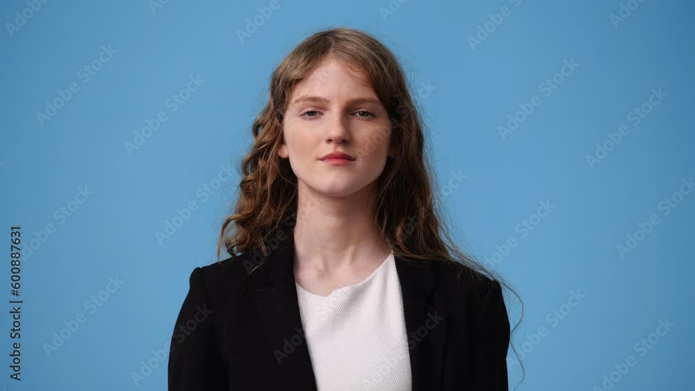4k video of one girl posing for a video over blue background. 4k video of one girl posing for a video over blue background.