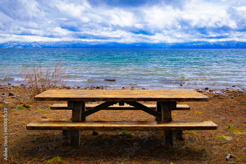 Empty picnic table, bench on west side, California side, west side of Lake Tahoe looking towards the Nevada side, east side of Lake Tahoe