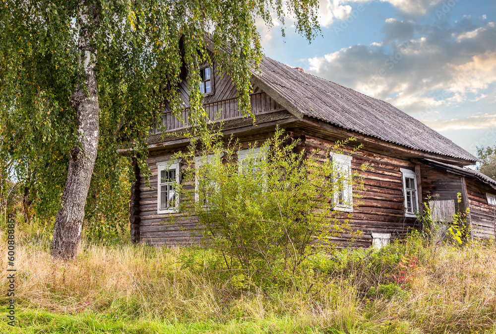 Countryside landscape with abandoned wooden house