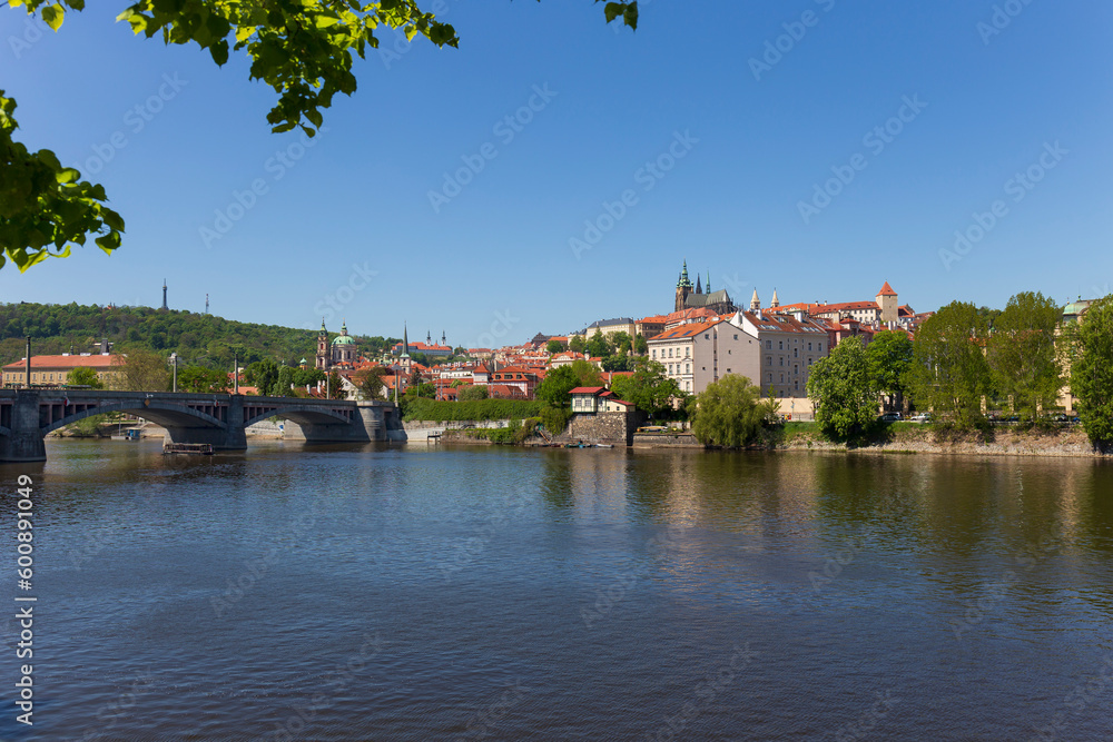 Spring colorful Prague Lesser Town with gothic Castle above River Vltava in the sunny Day, Czech Republic