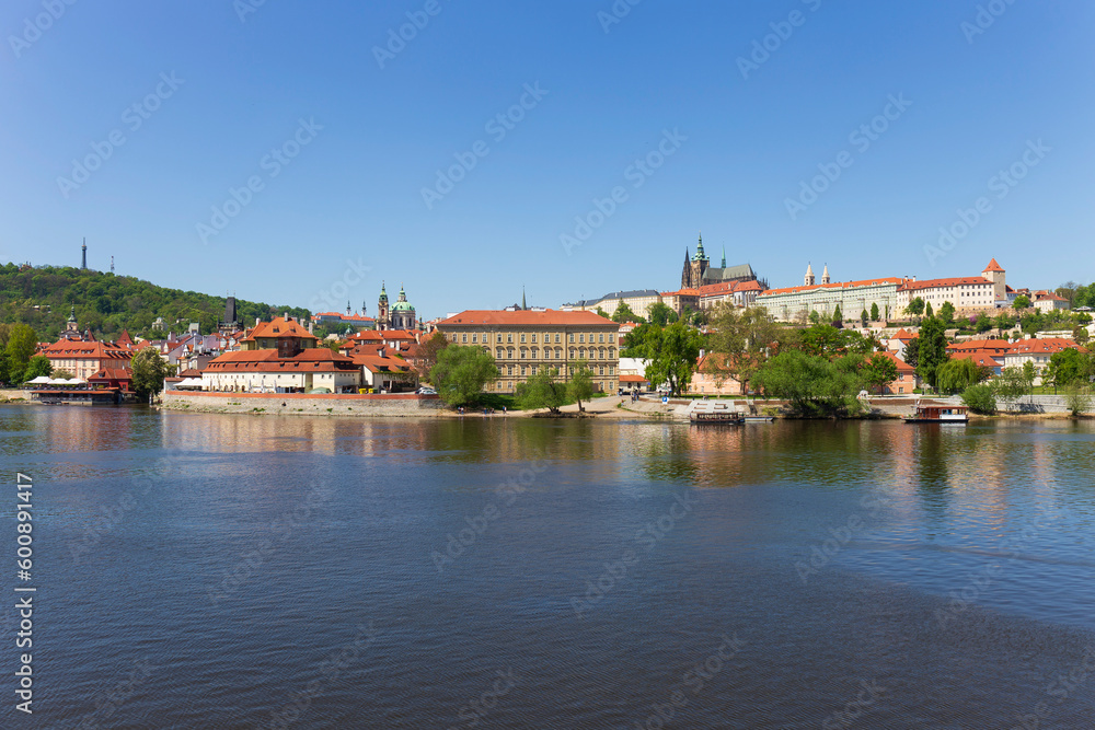 Spring colorful Prague Lesser Town with gothic Castle above River Vltava in the sunny Day, Czech Republic