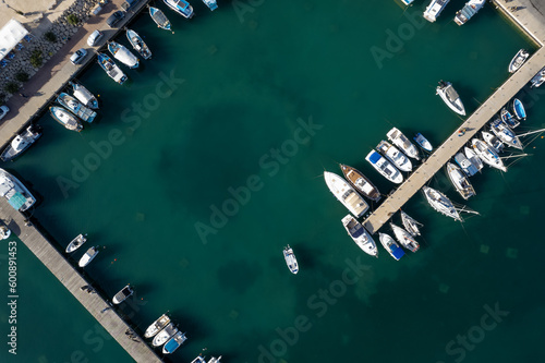 Drone aerial scenery of a fishing port. Fishing boats and yachts  moored in the harbour photo