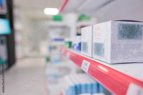 Fototapeta Naklejka Na Ścianę i Meble -  Aloe vera cream standing on pharmacy shelves waiting for customers to come and buy during checkup visit. Drugstore filled with pharmaceutical products and vitamins, supplements. Medicine concept