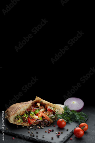 traditional pita sandwich with meat, vegetables, and sauce. Banner