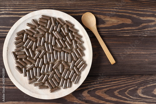 Brown pills on  plate, vitamons food supplement photo