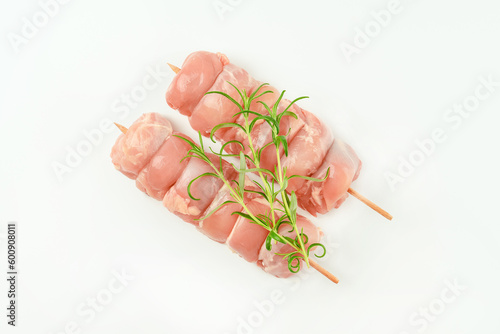 Chicken skewers.Food for retail.Skewers from raw chicken leg meat without skin for a supermarket on a white background.Chicken meat.Procurement for designers.