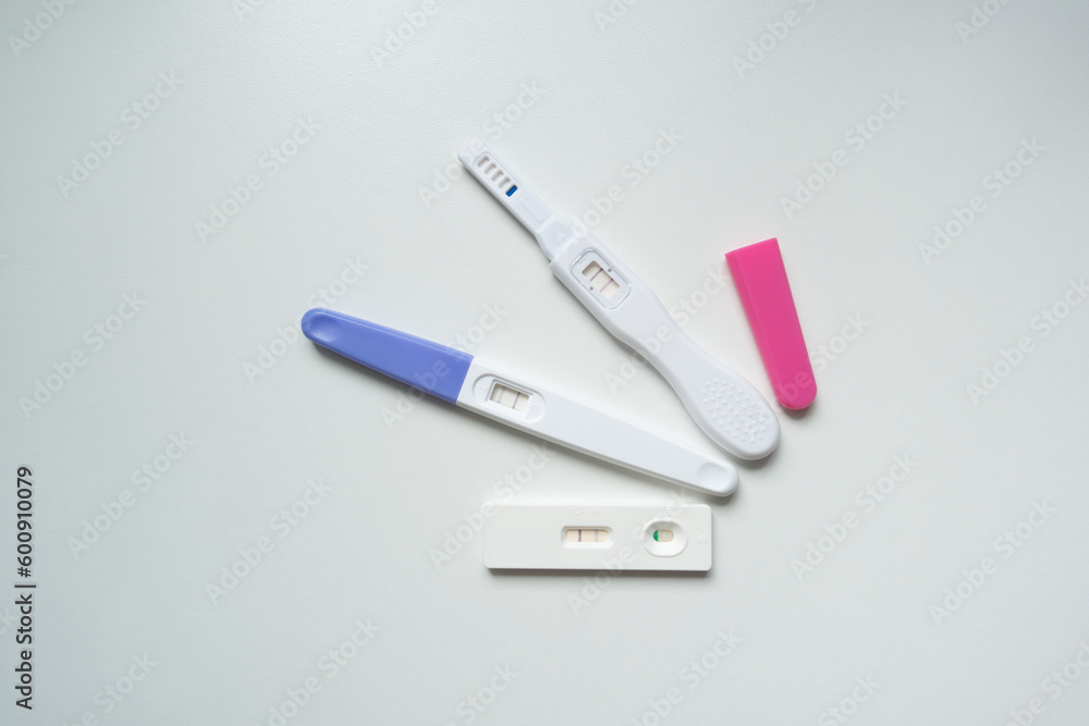 Planning pregnancy, health care concept. Positive pregnancy test isolated on white background, top view copy space.