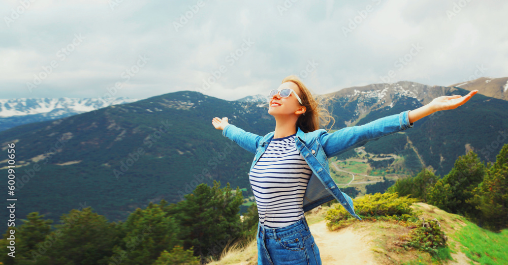 Obraz na płótnie Travel concept, happy woman enjoying fresh air mountains raising her hands up on Andorra mountain background w salonie