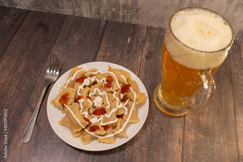 austrian cheese dumpling soup on wood with beer. photo