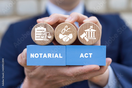 Notary holding colorful blocks with inscription: NOTARIAL ACT. Notary public service concept. Law and notarial act.