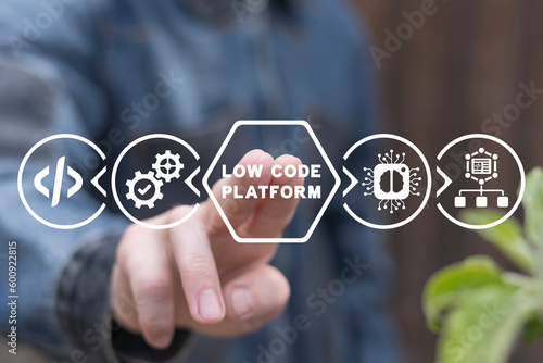 Foto Man using virtual touch screen presses inscription: LOW CODE PLATFORM