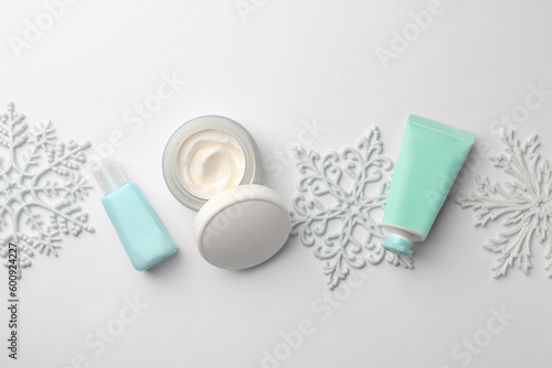 Winter skin care. Flat lay composition with hand cream and cosmetic products on white background