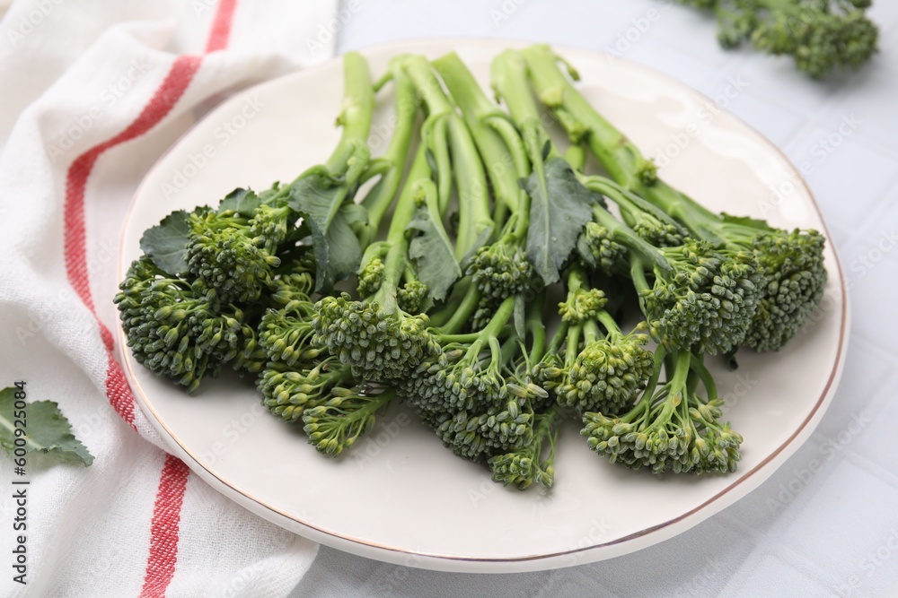 Fresh raw broccolini on white tiled table, closeup. Healthy food Fresh raw broccolini on white tiled table, closeup. Healthy food