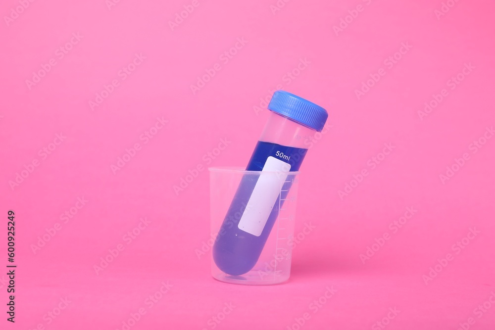 Beaker with test tube and liquid on bright pink background. Kids chemical experiment set Beaker with test tube and liquid on bright pink background. Kids chemical experiment set