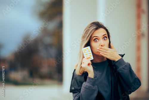Fotografie Woman Covering her Mouth Showing Vitamin Pills Tablet