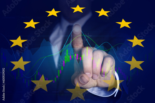 Stock exchange. Double exposure with European flag and man using digital screen with trading graphs photo