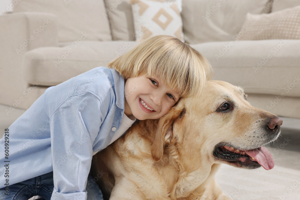 Cute little child with Golden Retriever at home. Adorable pet Cute little child with Golden Retriever at home. Adorable pet