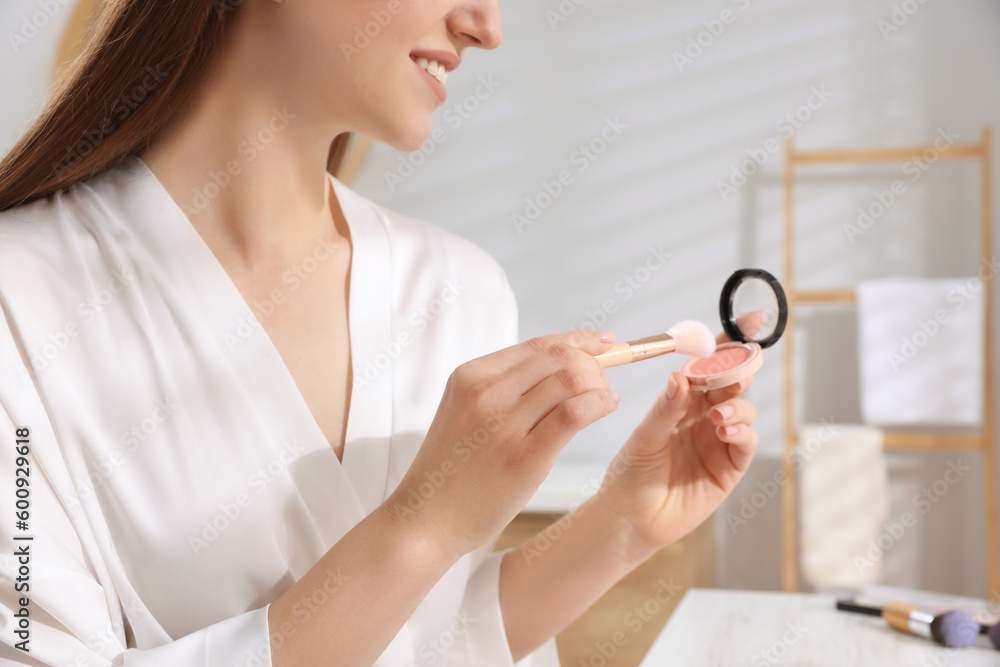 Woman with blusher and brush at dressing table indoors, closeup Woman with blusher and brush at dressing table indoors, closeup
